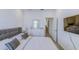 A calming bedroom features a TV, dresser, and doorway to another room at 625 Dogfish Ln, Debary, FL 32713