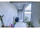 Covered entryway with outdoor grill, potted plants, and neutral tones at 625 Dogfish Ln, Debary, FL 32713