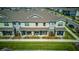 Aerial view of townhomes with manicured lawns and colorful landscaping at 625 Dogfish Ln, Debary, FL 32713