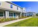 Attractive townhomes featuring covered entryways and beautifully landscaped lawns and shrubbery at 625 Dogfish Ln, Debary, FL 32713
