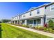 Attractive townhomes featuring covered entryways and beautifully landscaped lawns and shrubbery at 625 Dogfish Ln, Debary, FL 32713