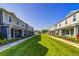 Street view of attractive townhomes featuring covered entryways and beautifully landscaped lawns and shrubbery at 625 Dogfish Ln, Debary, FL 32713