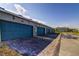 Row of garages with blue doors and brick-paved driveways providing convenient parking at 625 Dogfish Ln, Debary, FL 32713