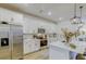 Contemporary kitchen boasting white cabinets, stainless steel appliances, and stylish pendant lighting above the island at 625 Dogfish Ln, Debary, FL 32713