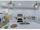Modern kitchen featuring white cabinetry, stainless steel appliances, and a large island with a sink at 625 Dogfish Ln, Debary, FL 32713