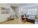 Charming living room showcasing a staircase, stylish seating, and artistic wall decorations at 625 Dogfish Ln, Debary, FL 32713