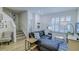 Stylish living room featuring a staircase, modern sofa, and a view of the entryway for seamless living at 625 Dogfish Ln, Debary, FL 32713