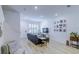 Bright living room featuring a comfy sofa, decorative wall art, and a staircase leading upstairs at 625 Dogfish Ln, Debary, FL 32713