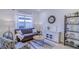 Inviting living room with a cozy sofa, patterned armchairs, and a decorative display shelf at 625 Dogfish Ln, Debary, FL 32713