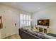 Cozy living room with a comfortable sofa, stylish decor, and ample natural light from shuttered windows at 625 Dogfish Ln, Debary, FL 32713