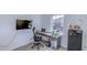 Well-appointed office space featuring a wall-mounted television, desk, and ergonomic chair at 625 Dogfish Ln, Debary, FL 32713