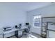 Bright office space with a large desk, multiple monitors, and natural light at 625 Dogfish Ln, Debary, FL 32713