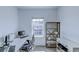 Bright office space with desk, computer, and shelving unit offering a functional work-from-home environment at 625 Dogfish Ln, Debary, FL 32713