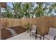 Private backyard patio area with a wooden fence, seating, and decorative landscaping at 752 Howland Ln # 114, Altamonte Springs, FL 32701