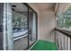 Enclosed balcony with view of bedroom featuring sliding door to a carpeted area at 752 Howland Ln # 114, Altamonte Springs, FL 32701