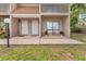 Two-story townhouse exterior with neutral siding, a walkway, and an area for plants at 752 Howland Ln # 114, Altamonte Springs, FL 32701