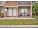 Two-story townhouse exterior with neutral siding, a walkway, and an area for plants at 752 Howland Ln # 114, Altamonte Springs, FL 32701