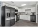 Stylish kitchen with stainless steel appliances, white cabinets, and a tiled backsplash at 752 Howland Ln # 114, Altamonte Springs, FL 32701
