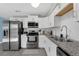 Modern kitchen featuring stainless steel appliances, granite countertops, and white cabinetry at 752 Howland Ln # 114, Altamonte Springs, FL 32701