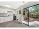 Bright kitchen features white cabinetry, stainless steel appliances, and sliding glass doors to the backyard at 752 Howland Ln # 114, Altamonte Springs, FL 32701