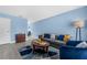 Comfortable living room with modern blue decor, stylish furniture, and bright natural light at 752 Howland Ln # 114, Altamonte Springs, FL 32701