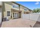 Townhouse backyard featuring a brick patio and white fence for privacy at 7715 Anselmo Ln, Windermere, FL 34786