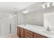 Bathroom featuring double sinks, a shower with glass door, and modern lighting fixtures at 7715 Anselmo Ln, Windermere, FL 34786