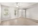 Airy, neutrally decorated bedroom with two windows at 7715 Anselmo Ln, Windermere, FL 34786