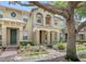 Inviting townhome exteriors with covered entrances and manicured landscaping at 7715 Anselmo Ln, Windermere, FL 34786
