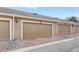 Row of garages with brown doors and brick driveways at 7715 Anselmo Ln, Windermere, FL 34786