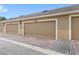 Tan garages with brick driveways under a sunny sky at 7715 Anselmo Ln, Windermere, FL 34786