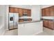 Bright kitchen features stainless steel appliances, granite countertops and center island with bar seating at 7715 Anselmo Ln, Windermere, FL 34786