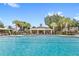 Community pool area with a clubhouse and seating at 7715 Anselmo Ln, Windermere, FL 34786