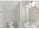 This half bathroom features a modern vanity with oval mirror and sleek lighting fixtures at 7715 Anselmo Ln, Windermere, FL 34786