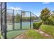 Fenced tennis court in a community setting with green surroundings at 7715 Anselmo Ln, Windermere, FL 34786