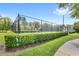 View of community tennis court surrounded by lush landscaping at 7715 Anselmo Ln, Windermere, FL 34786