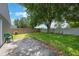 Spacious backyard featuring lush green grass, a mature tree, and a concrete patio area, perfect for outdoor activities at 8141 Golden Chickasaw Cir, Orlando, FL 32825