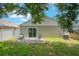 Charming backyard showcasing a quaint patio with seating and a verdant lawn, ideal for relaxation and outdoor entertainment at 8141 Golden Chickasaw Cir, Orlando, FL 32825