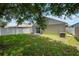 Well-maintained backyard offers a private outdoor retreat with a sliding glass door leading to a cozy patio area at 8141 Golden Chickasaw Cir, Orlando, FL 32825