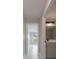 Hallway view leads to bathroom with grey vanity, black fixtures and framed mirror at 8141 Golden Chickasaw Cir, Orlando, FL 32825