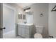 Well-lit bathroom featuring grey vanity, black fixtures, and a sleek mirror at 8141 Golden Chickasaw Cir, Orlando, FL 32825