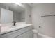Stylish bathroom with grey vanity, sleek mirror, black fixtures and a toilet at 8141 Golden Chickasaw Cir, Orlando, FL 32825