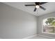Inviting bedroom with neutral walls, tiled floors, ceiling fan, and ample sunlight at 8141 Golden Chickasaw Cir, Orlando, FL 32825