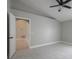 Spacious bedroom features a ceiling fan and a doorway leading into another room at 8141 Golden Chickasaw Cir, Orlando, FL 32825