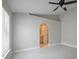 Spacious bedroom featuring a ceiling fan and an arched entrance to the ensuite bathroom at 8141 Golden Chickasaw Cir, Orlando, FL 32825