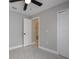 A cozy bedroom features neutral walls, a ceiling fan, and sleek, modern tiled floors at 8141 Golden Chickasaw Cir, Orlando, FL 32825