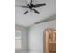 Bedroom with a ceiling fan, neutral paint, and an arched entrance to the ensuite bathroom at 8141 Golden Chickasaw Cir, Orlando, FL 32825