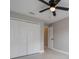 Bedroom featuring neutral walls, tiled floors, ceiling fan, and closet space at 8141 Golden Chickasaw Cir, Orlando, FL 32825