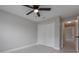 Cozy bedroom featuring neutral walls, tiled floors, ceiling fan, and closet for storage at 8141 Golden Chickasaw Cir, Orlando, FL 32825
