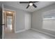 Bright bedroom with tile flooring, ceiling fan, and closet for ample storage at 8141 Golden Chickasaw Cir, Orlando, FL 32825